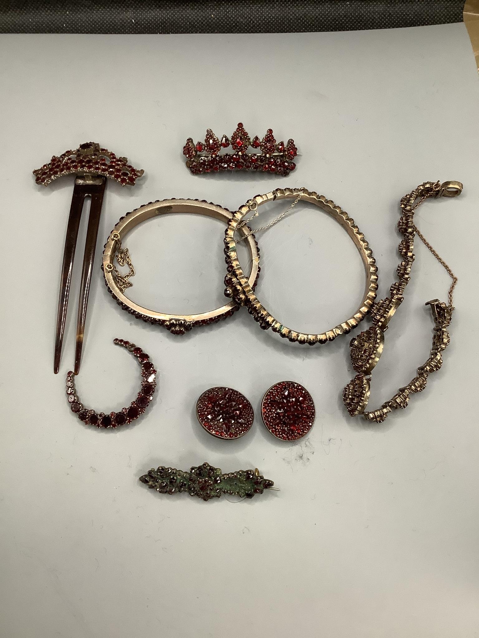 A small group of mixed Victorian gilt white metal and garnet set jewellery, including bangles, brooches, bracelet and hair ornament.